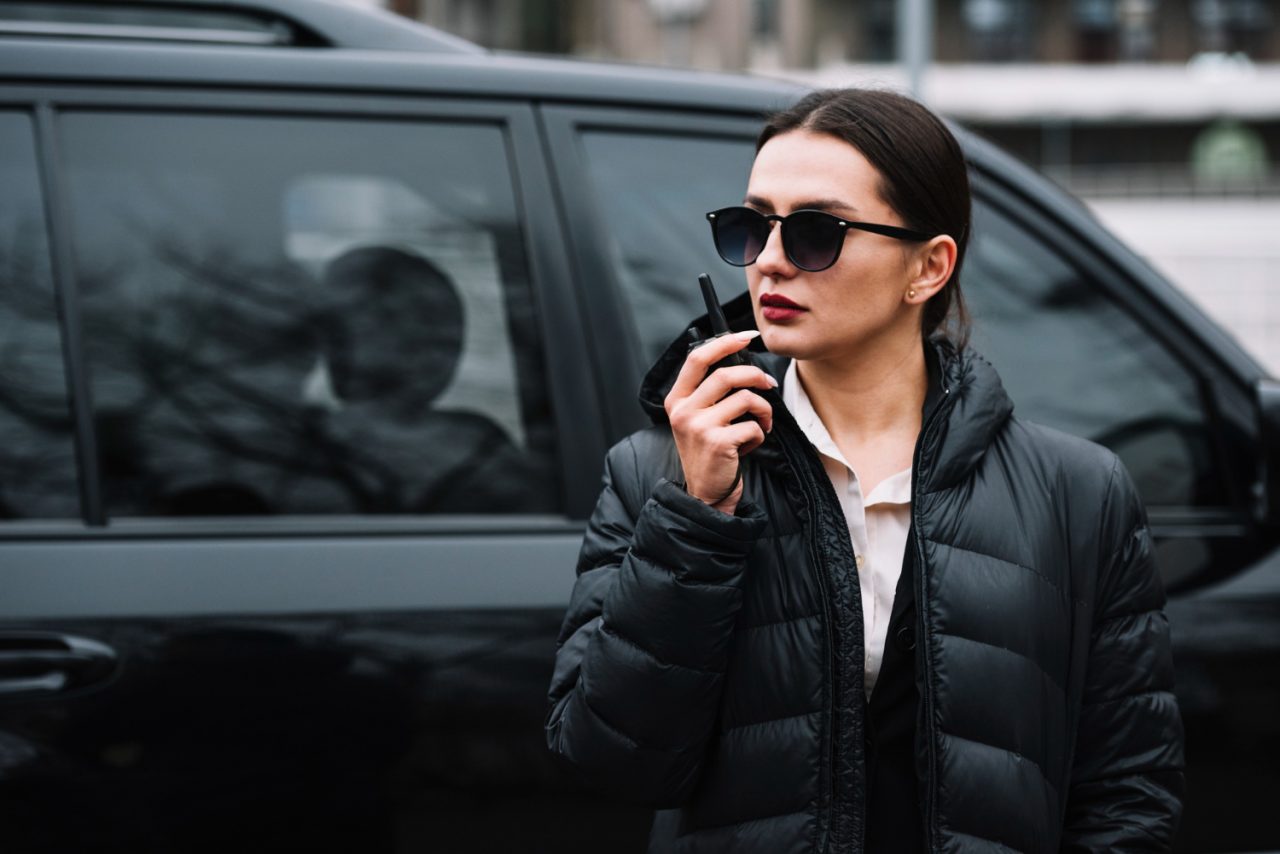 Female security guard in London with professional equipment, providing high-level security services